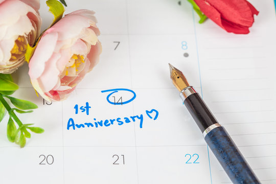 word anniversary celebration plan on calendar with flower and pen