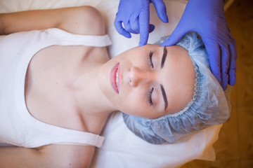 Obraz na płótnie Canvas Cosmetology doctor doing massage person woman
