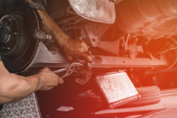Car mechanic repairing brakes pads auto repair in garage, Professional car service automobile