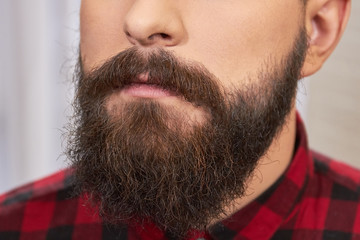 Beard of a young man. Facial hair close up. Benefits of growing a beard.
