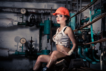 Fototapeta na wymiar Beautiful girl wearing a helmet in the boiler room
