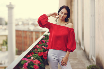 Beautiful syulish girl outdoor portrait. Summer style. Fashionable woman wearing red blouse and...