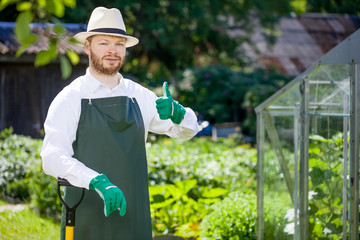 portrait of a smiling greenhouse worker