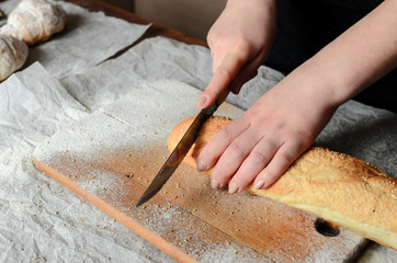 Sliced bread on a wooden board.