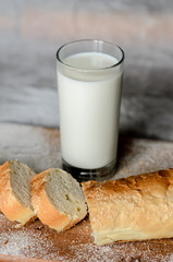 Still life of a glass of milk and sliced bread.
