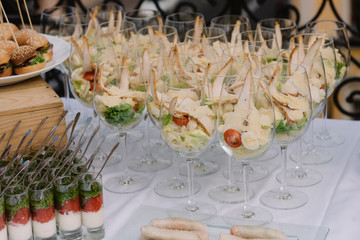 Tasty salad served in the wineglasses