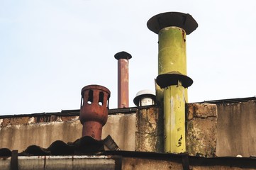 different kind of chimneys on the rooftop
