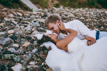 Beautiful wedding couple on a walk by the sea