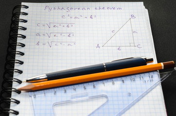 Page with formulas and the Pythagorean theorem with pen and pencil