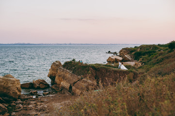 Beautiful wedding couple on a walk by the sea