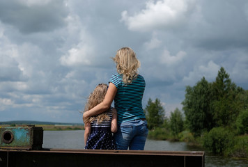 Mother and daughter looking out at the lake