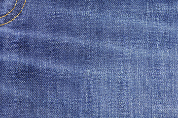 Naklejka premium Denim jeans fabric texture background with seam for beauty, fashion and clothing idea concept design.