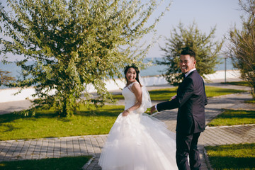 Wedding couple on a promenade on the waterfront