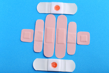 Medical plasters on blue background