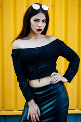 Gorgeous brunette girl with a beautiful make-up in fashionable clothes: a black jacket with a bare...