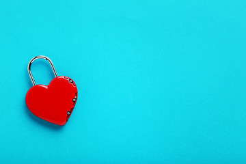Heart shaped padlock on blue background