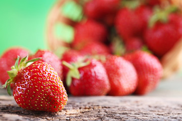 Fresh strawberries on grey wooden table