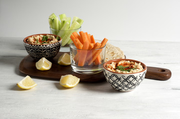 Homemade hummus with pita, carrot and cucumber sticks