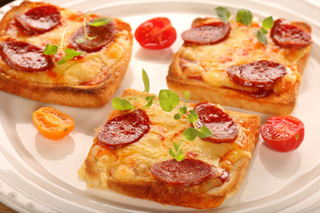 Fresh toast with melted cheese and chorizo sausage