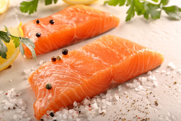 Fried cod fillet on a white plate and french fries