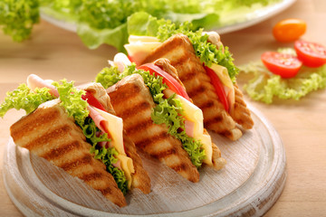 Fresh sandwiches on wooden background