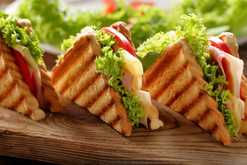 Fresh sandwiches on wooden background