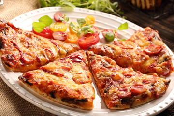 Homemade pizza on a white plate