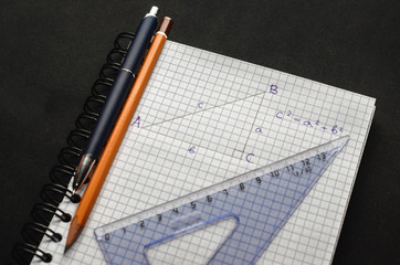 Page with formulas and the Pythagorean theorem with pen, pencil and ruler