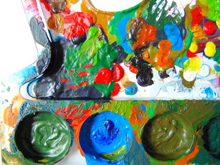 Fototapeta na wymiar colorful dried paint on mixing palette with painting brush
