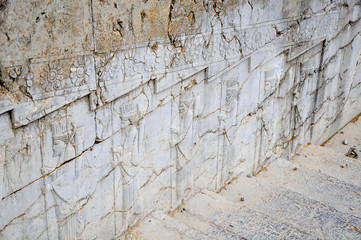 the ruins of the ancient Persepolis, ancient bas-reliefs decorating a wall along a ladder