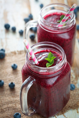 Berries smoothies in glass with blueberries