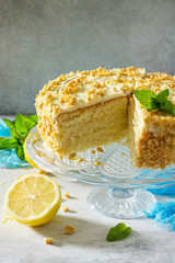 Delicious birthday cake lemon biscuit and butter cream, walnut roasted. Serving of a festive table. Copy space.