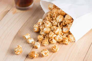 Popcorn in bag on table.