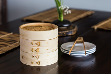 bamboo steamer set on the dinning table.