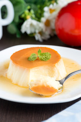 Caramel custard pudding in white plate.