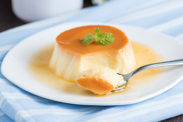 Caramel custard pudding in white plate.