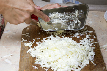 hands slicing cabbage