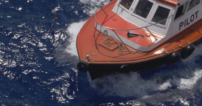 A high angle aerial view of the bow of a small pilot boat as it travels in Havana Port Bay.	Shot at 48fps.  	