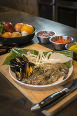 Raw seafood on plate with fruits and vegetables, healthy food, prawn, clam squid