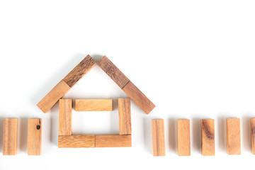 Wooden block stacking as house isolated on white background