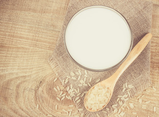 Rice milk on the wooden background .