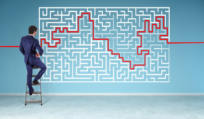 Businessman searching maze solution on a wall 3D rendering