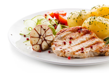 Grilled steak, boiled potatoes and vegetable salad on white background