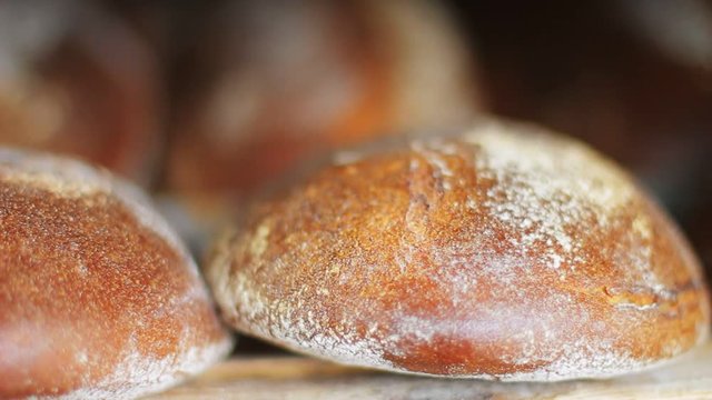 Fresh baked bread close up. Bakery products. Fresh bakery production. Loaf of bread. Freshly baked bread on production line. Cereal bread loaf. Food manufacturing. line. Food factory. Food industry