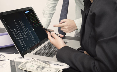 business hand point on laptop with Finance Trading Stock Graph Chart homepage on computer screen. invesment analysis concept.