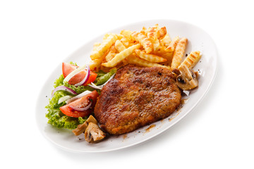 Fried pork chop, French fries and vegetable salad on white background