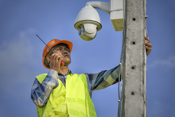 technician with radio communication in action orient the camera cctv - 165305919