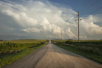Poster Im Rahmen Rural road with dramatic clouds in southern Minnesota at sundown © Daniel Thornberg