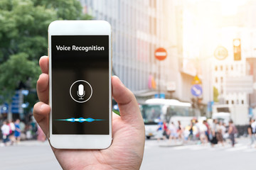 Voice recognition , speech detect and deep learning concept. Application on mobile phone screen with blur city background.