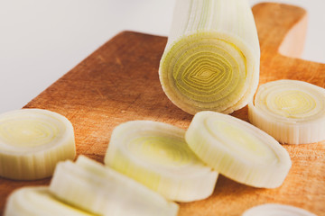 Sliced and chopped leek closeup on wood background